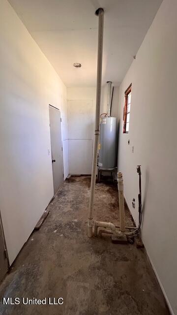 hallway with gas water heater and unfinished concrete floors