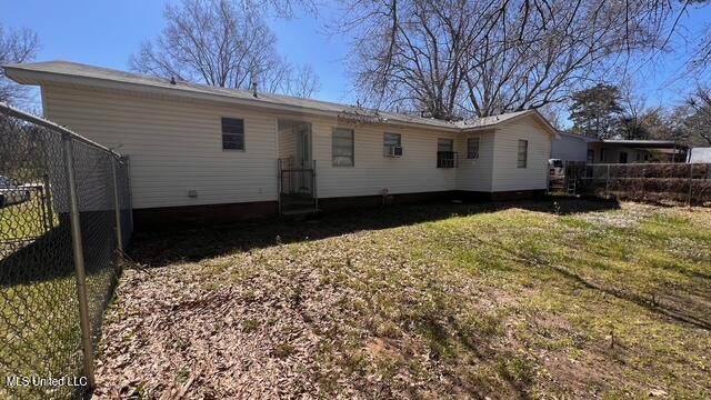 back of house featuring fence