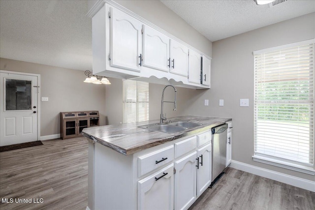 6967 Green Way Cv, Olive Branch, MS 38654 - kitchen with dishwasher, a textured ceiling, light wood finished floors, and white cabinetry
