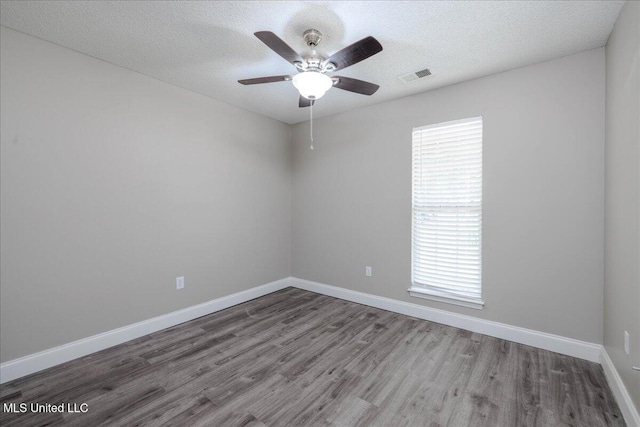 6967 Green Way Cv, Olive Branch, MS 38654 - spare room featuring wood finished floors, ceiling fan, and a textured ceiling