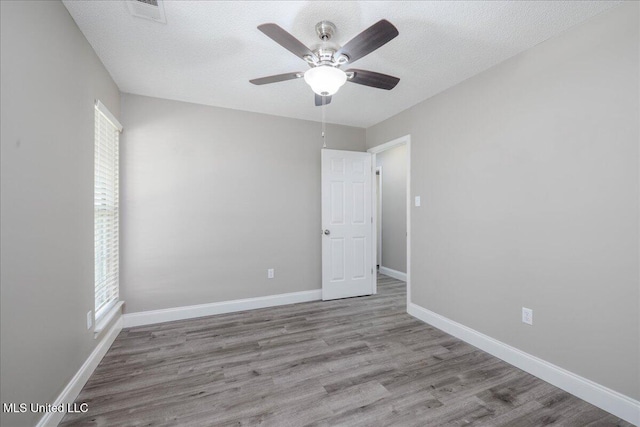 6967 Green Way Cv, Olive Branch, MS 38654 - empty room featuring wood finished floors, ceiling fan, and a textured ceiling