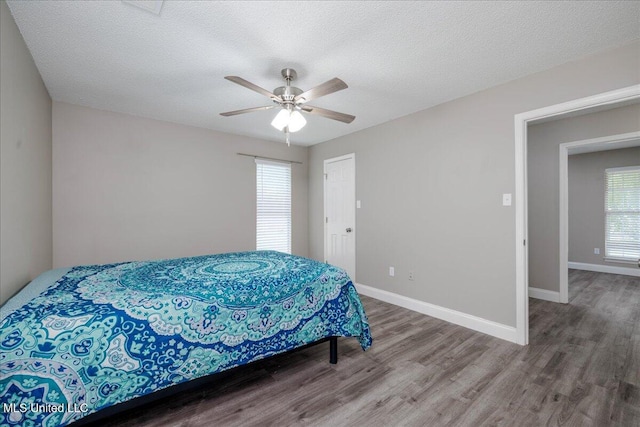 6967 Green Way Cv, Olive Branch, MS 38654 - bedroom with wood finished floors, a ceiling fan, and a textured ceiling