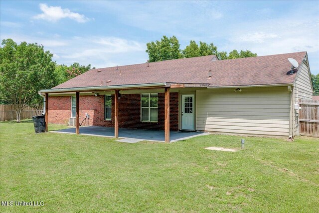 6967 Green Way Cv, Olive Branch, MS 38654 - rear view of property featuring a patio area, roof with shingles, and brick siding