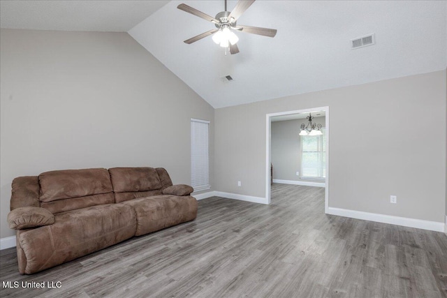 6967 Green Way Cv, Olive Branch, MS 38654 - living area with a chandelier, ceiling fan, high vaulted ceiling, and wood finished floors