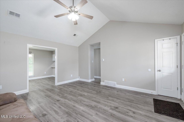 6967 Green Way Cv, Olive Branch, MS 38654 - unfurnished living room with a ceiling fan, vaulted ceiling, and wood finished floors