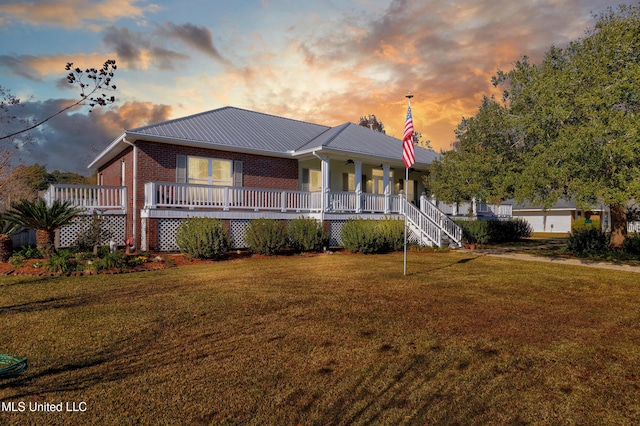 view of front of house with a lawn and covered porch