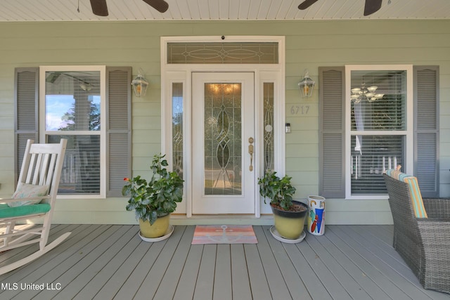 view of exterior entry with ceiling fan and covered porch