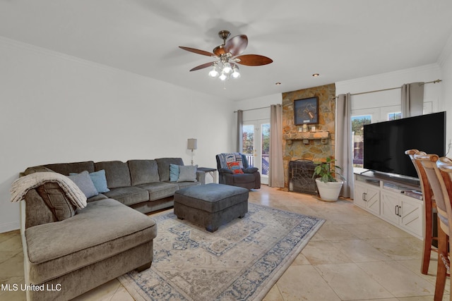 tiled living room with ceiling fan and crown molding