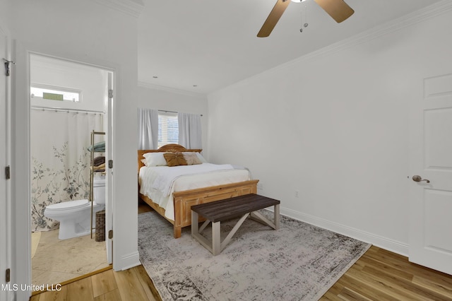 bedroom featuring wood-type flooring, ensuite bathroom, ceiling fan, and ornamental molding