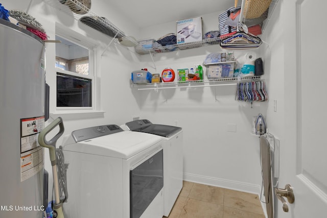 washroom with washer and clothes dryer, electric water heater, and light tile patterned floors