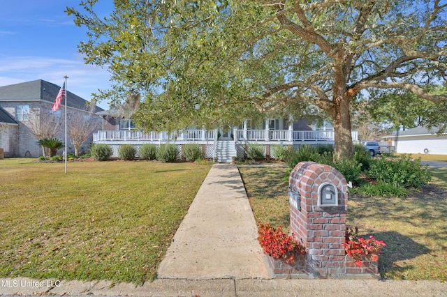 obstructed view of property with covered porch and a front yard