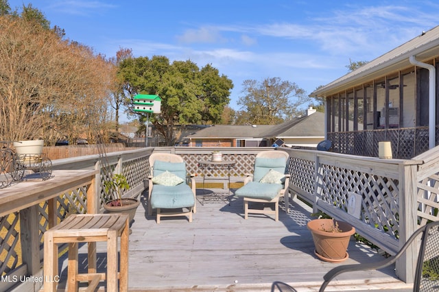 wooden deck with a sunroom