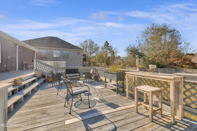 wooden terrace featuring an outdoor hangout area