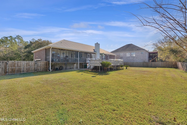 view of yard featuring a sunroom and a wooden deck