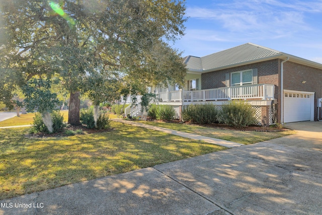 view of front facade with a porch, a garage, and a front lawn