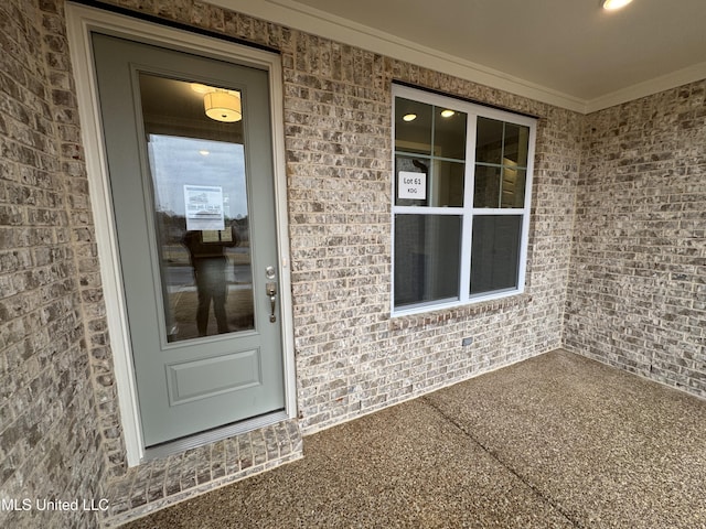 view of exterior entry with brick siding