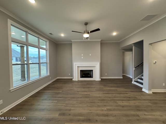 unfurnished living room with ceiling fan, crown molding, dark wood-type flooring, and a water view