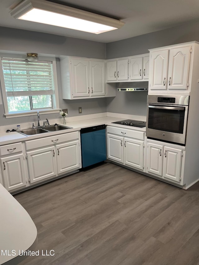 kitchen featuring oven, white cabinets, dishwasher, black electric stovetop, and sink