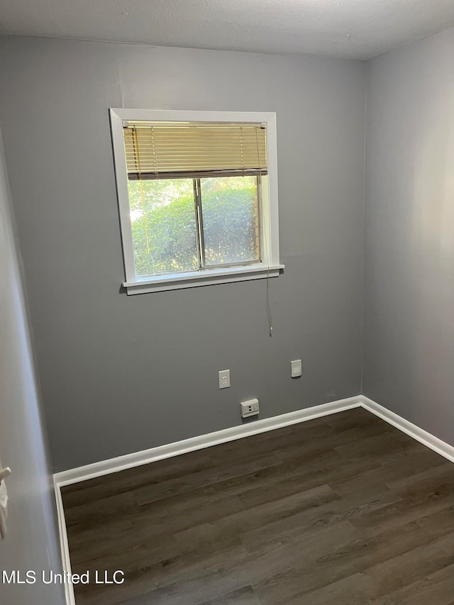 empty room featuring dark hardwood / wood-style floors