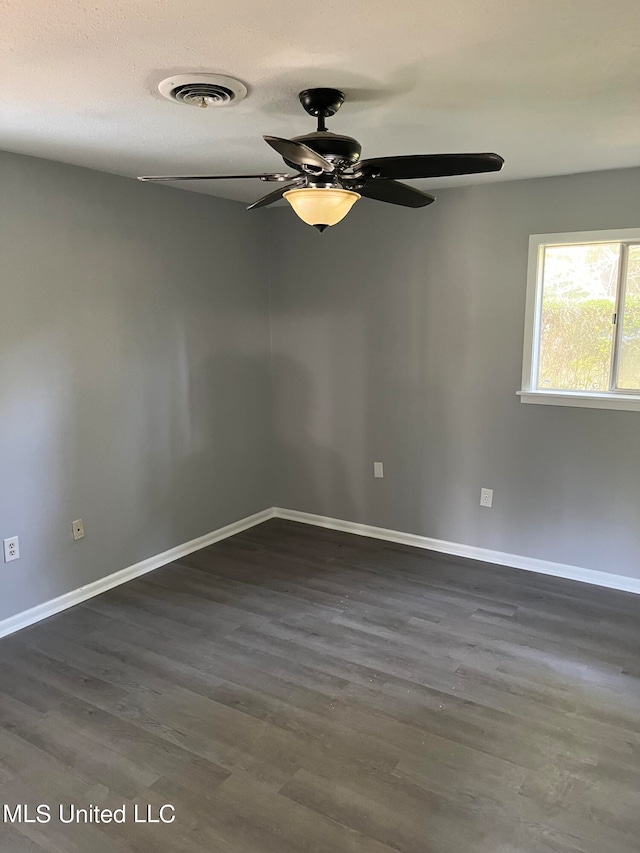 unfurnished room featuring ceiling fan and dark hardwood / wood-style floors