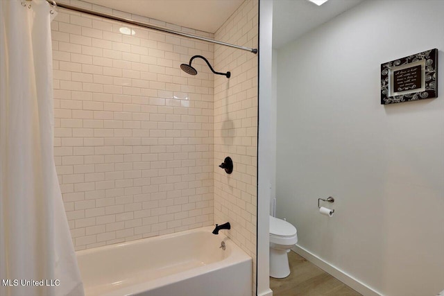 full bath with toilet, shower / bathtub combination with curtain, baseboards, and wood finished floors