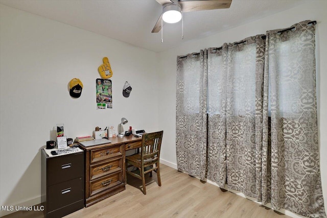 office space with ceiling fan, baseboards, and light wood-style floors