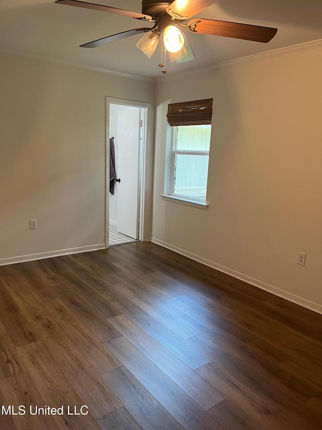 unfurnished room with ceiling fan, ornamental molding, dark wood-type flooring, and baseboards