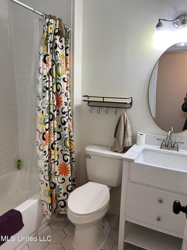 bathroom featuring shower / bath combo, vanity, toilet, and tile patterned floors