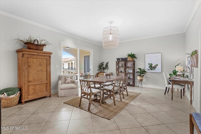 dining room featuring a notable chandelier, ornamental molding, and light tile patterned floors