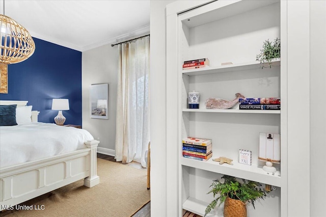 bedroom featuring crown molding and hardwood / wood-style floors