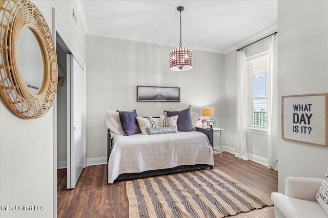 bedroom with crown molding and dark hardwood / wood-style floors