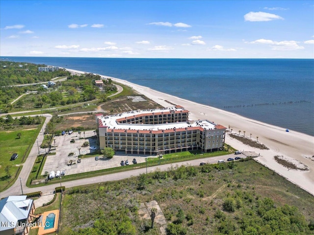 drone / aerial view featuring a water view and a beach view