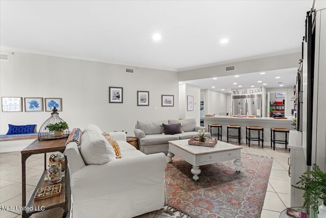 living room with crown molding and light tile patterned flooring