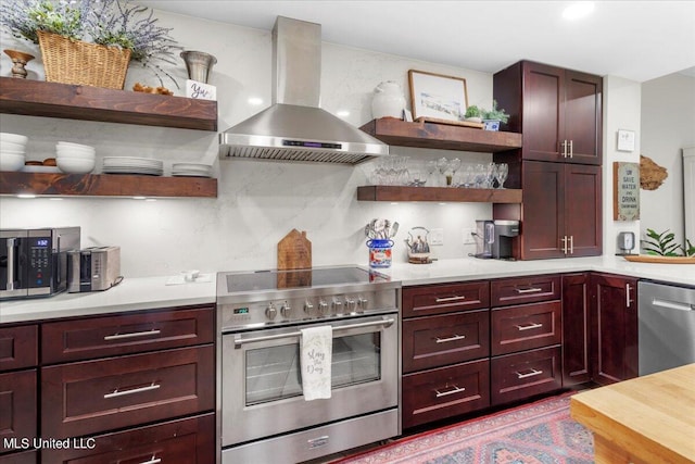 kitchen with wall chimney exhaust hood and appliances with stainless steel finishes