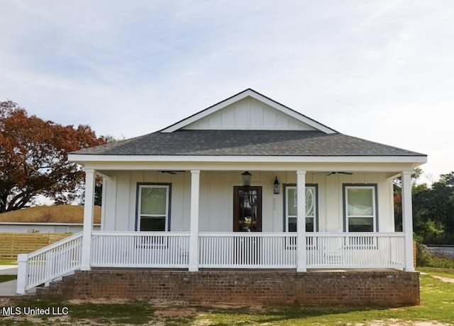 view of front of home with board and batten siding, covered porch, and a shingled roof