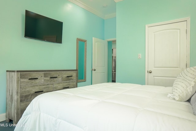 bedroom with crown molding and freestanding refrigerator