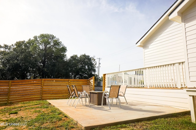 view of patio featuring fence private yard and a fire pit