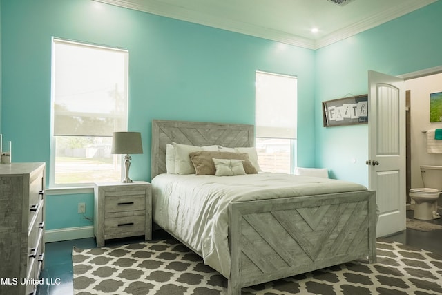 bedroom with baseboards, visible vents, and ornamental molding