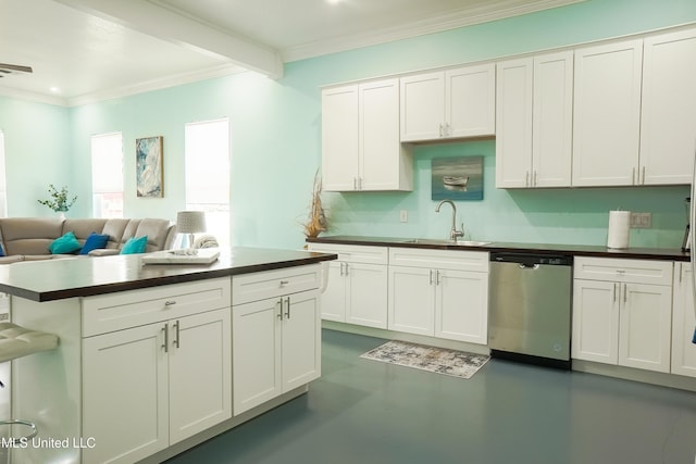 kitchen with dark countertops, white cabinetry, dishwasher, and a sink