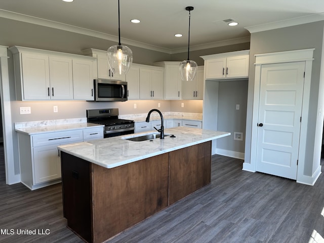 kitchen featuring a sink, a kitchen island with sink, white cabinetry, appliances with stainless steel finishes, and ornamental molding