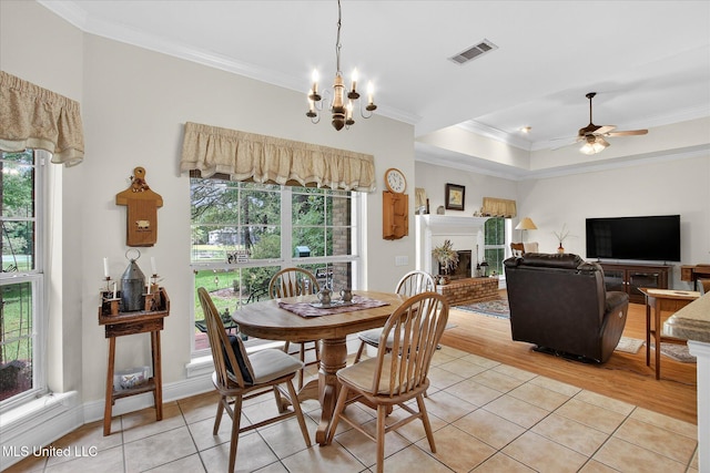 7622 Fairway Dr, Diamondhead, MS 39525 - dining space with crown molding, healthy amount of natural light, ceiling fan, light tile patterned flooring, and a chandelier