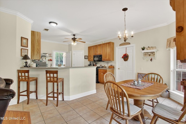 7622 Fairway Dr, Diamondhead, MS 39525 - dining space featuring light tile patterned flooring, crown molding, and a ceiling fan