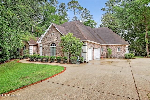 7622 Fairway Dr, Diamondhead, MS 39525 - view of front of house with brick siding, an attached garage, concrete driveway, a front yard, and roof with shingles