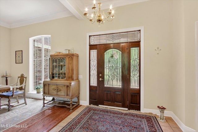 7622 Fairway Dr, Diamondhead, MS 39525 - foyer entrance with a chandelier, ornamental molding, beamed ceiling, and light tile patterned floors
