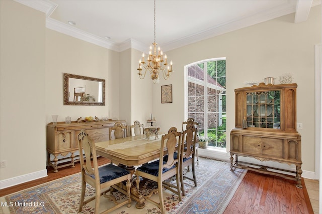 7622 Fairway Dr, Diamondhead, MS 39525 - dining area with a chandelier, wood finished floors, and crown molding
