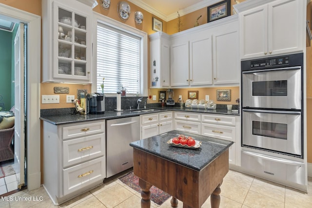 1616 Poplar Blvd, Jackson, MS 39202 - kitchen featuring stainless steel appliances, a sink, a warming drawer, light tile patterned floors, and ornamental molding
