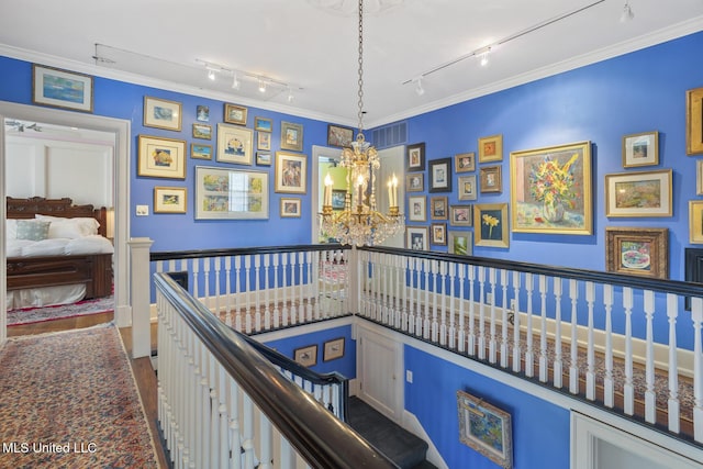 1616 Poplar Blvd, Jackson, MS 39202 - interior space featuring rail lighting, a chandelier, an upstairs landing, and crown molding