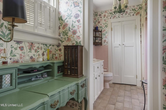 1616 Poplar Blvd, Jackson, MS 39202 - bathroom featuring wallpapered walls, wainscoting, toilet, and a chandelier