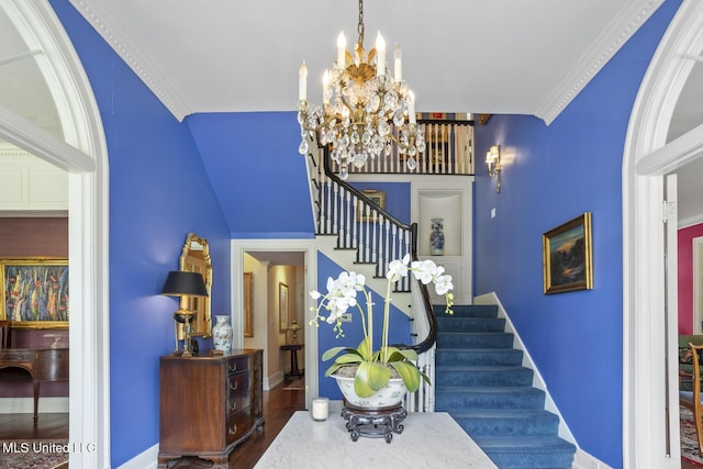 1616 Poplar Blvd, Jackson, MS 39202 - staircase featuring a chandelier, baseboards, wood finished floors, and ornamental molding