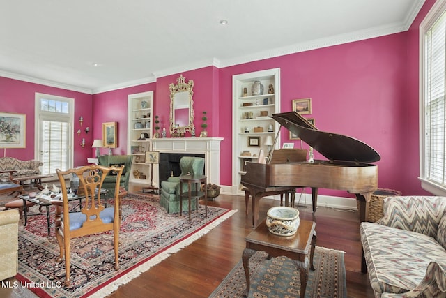 1616 Poplar Blvd, Jackson, MS 39202 - living area with built in shelves, wood finished floors, ornamental molding, baseboards, and a fireplace